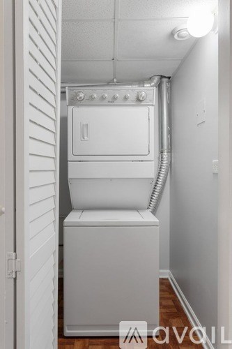 A white oven and dishwasher in a narrow hallway.