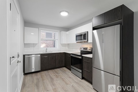 A kitchen with a white fridge and a white door.