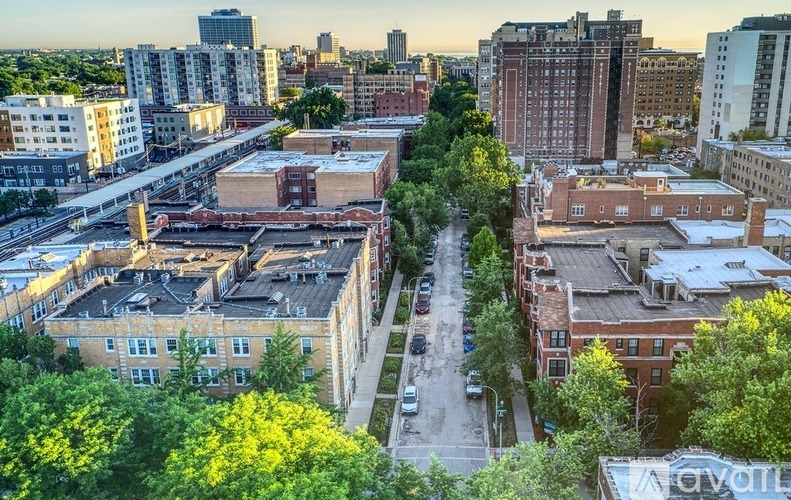 A cityscape with buildings and trees in the foreground.