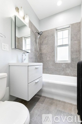 A bathroom with a toilet, sink, and bathtub.