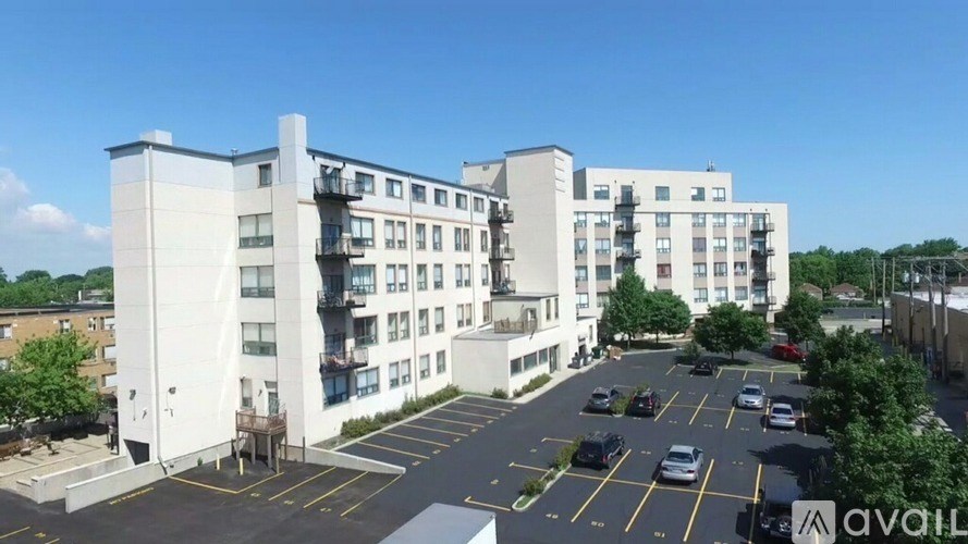 A large white building with a parking lot in front of it.