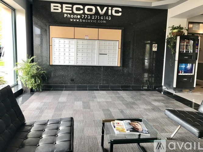 A black and white office lobby with a sign that says "Becovic" on the wall.