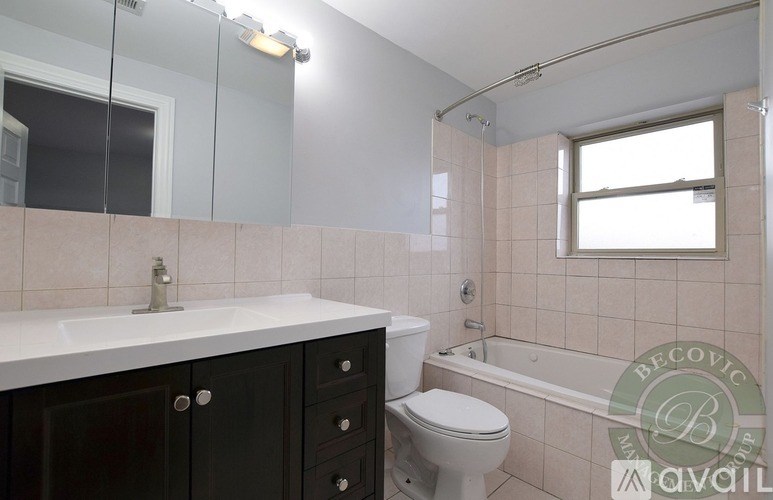 A bathroom with a toilet, sink, and bathtub.