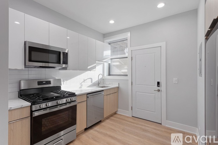 A kitchen with a stove, oven, and microwave.