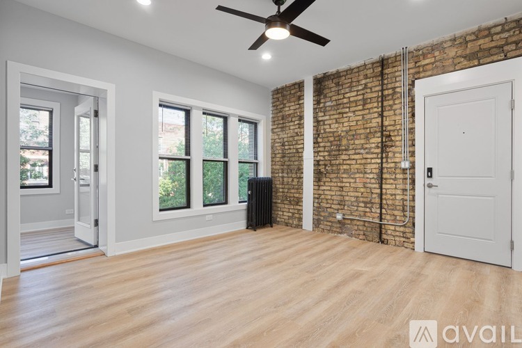 A room with a brick wall and wooden flooring.