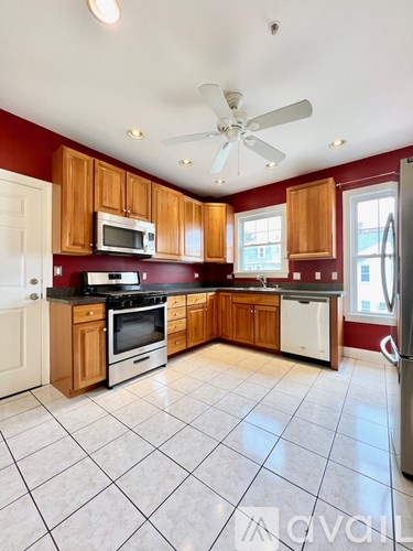 A kitchen with wooden cabinets and a white refrigerator.