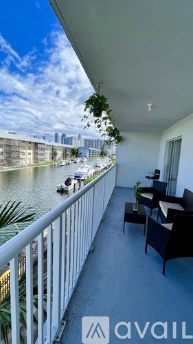 A balcony with a view of a river and boats with a sign that says "available".