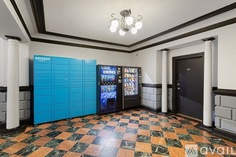 A room with a vending machine and a fridge.