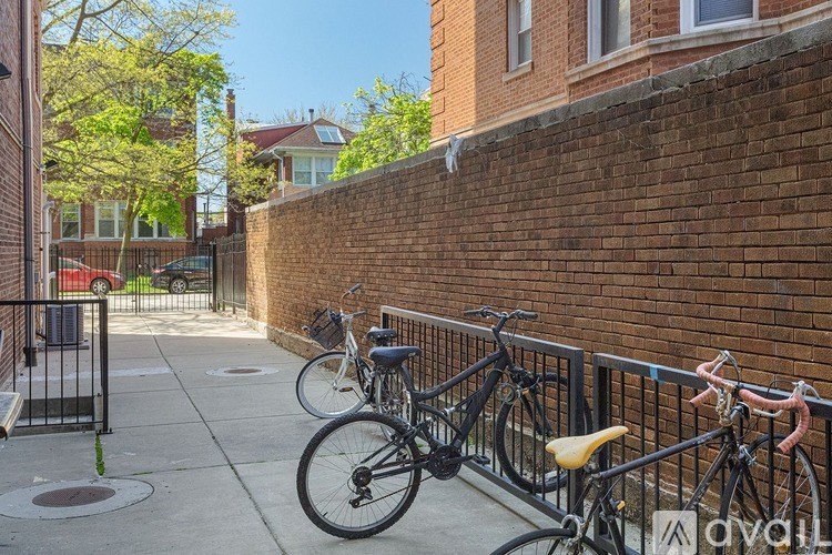 A bicycle is parked on a sidewalk next to a brick wall.
