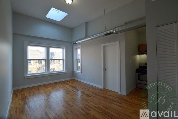 A room with wooden floors and a skylight.