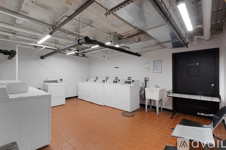 A room with white cabinets and a black monitor on a desk.