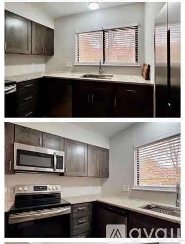 A kitchen with dark brown cabinets and a stove top oven.