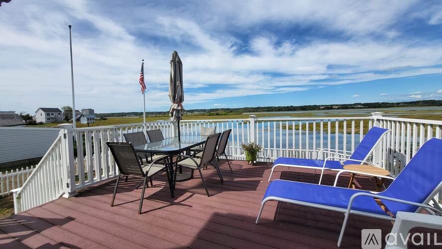 A deck with chairs and a table is available for rent.