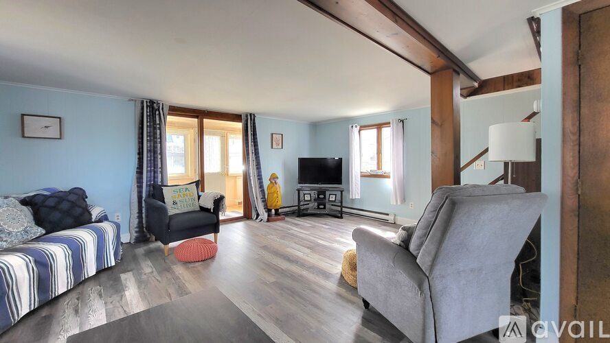 A living room with a grey sofa and a grey armchair.