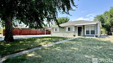 A house with a tree in front of it is for sale.