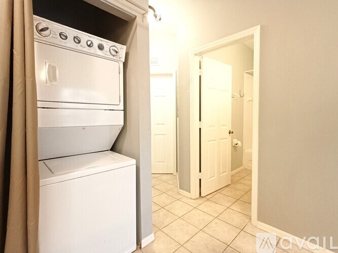 A white oven and dishwasher in a small room.