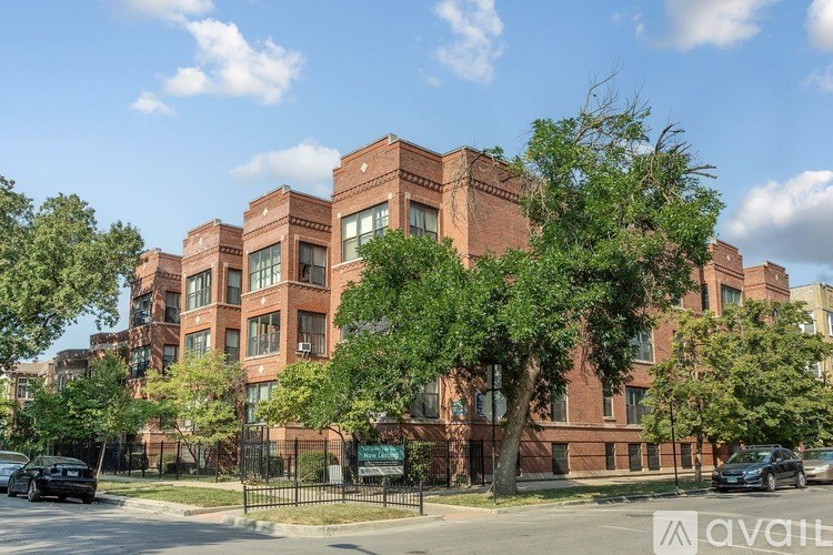 A large red brick building with trees in front of it.