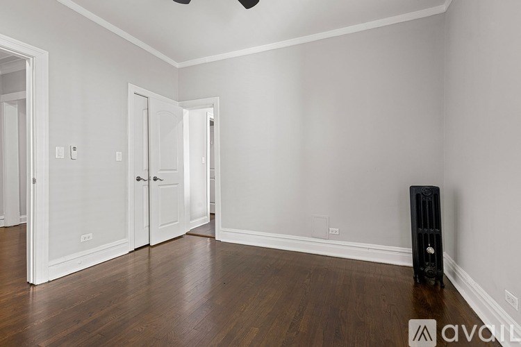 A room with a black speaker on the floor.