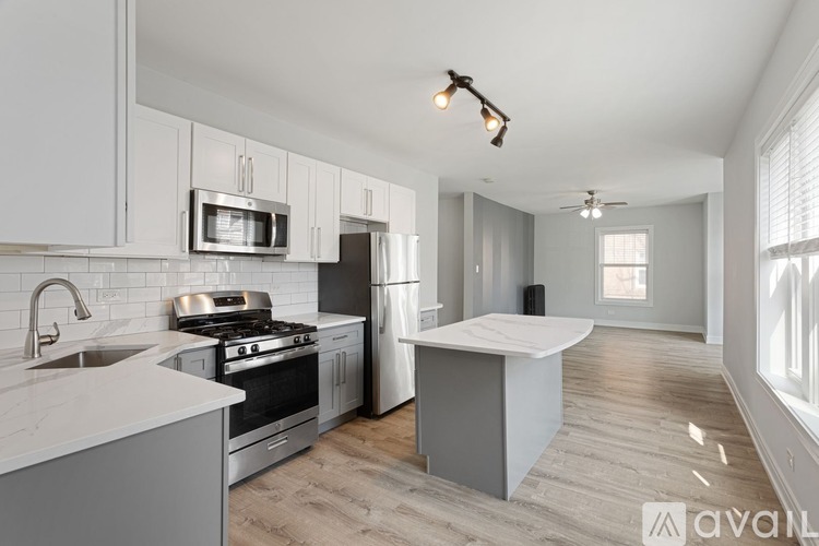 A kitchen with a stove, oven, and microwave.