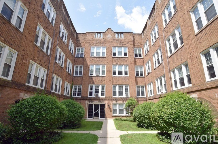 A large brick building with a courtyard in the middle.