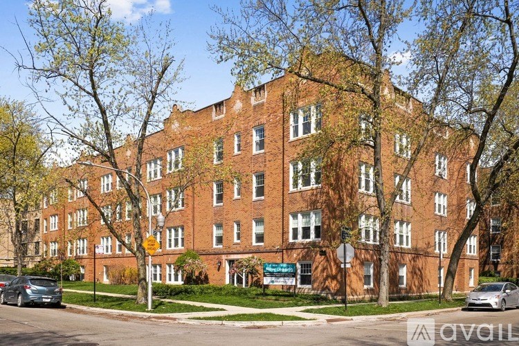 A large red brick building with a blue sign in front.