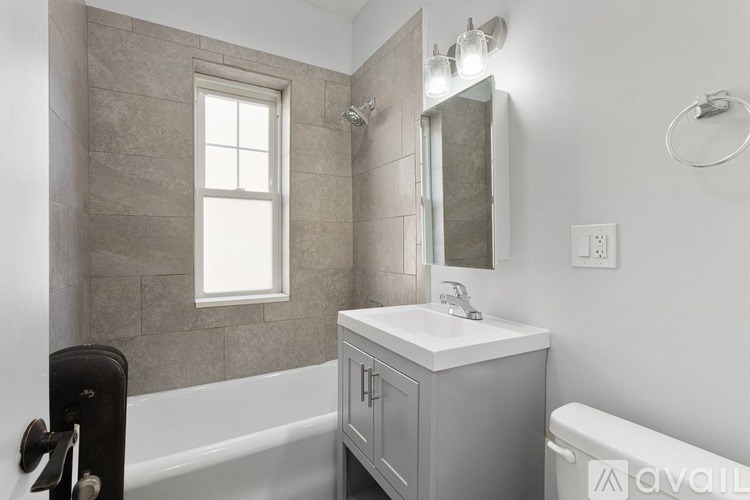 A bathroom with a sink, mirror, and tub.