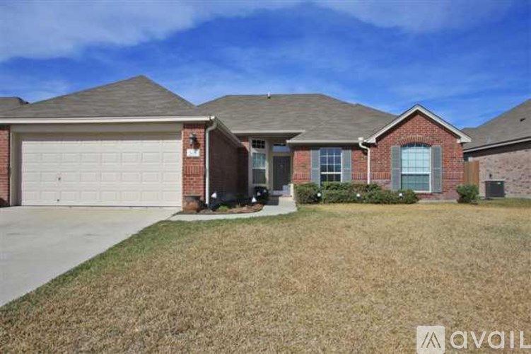 A house with a garage and a driveway in front.