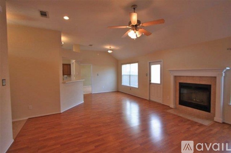 A spacious living room with hardwood floors and a fireplace.