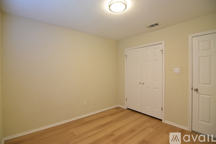 A room with two doors and a light on the ceiling.