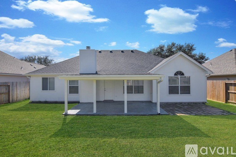 A house with a white exterior and a grey roof is available for sale.