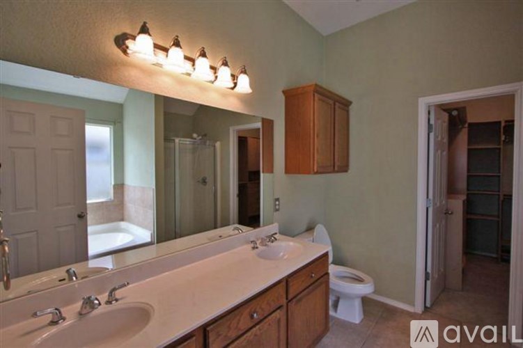 A bathroom with a white countertop and a white toilet.