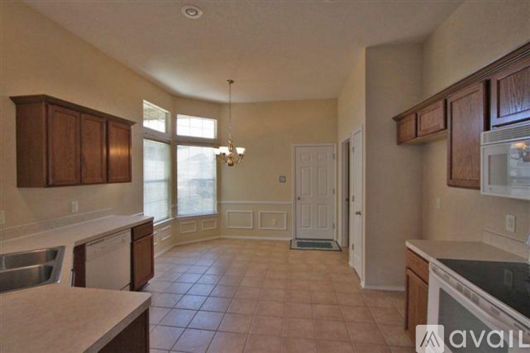A kitchen with a dishwasher and a refrigerator.