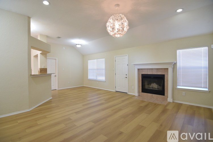 A room with a ceiling fan and a window with blinds.