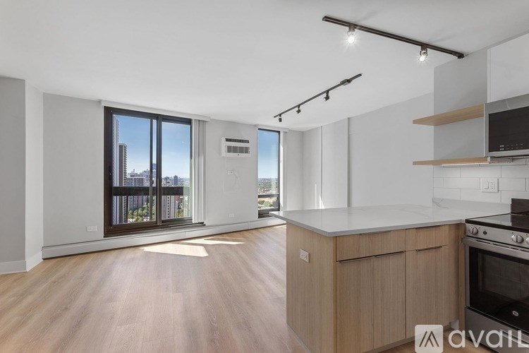 A kitchen with wooden floors and a stainless steel oven.
