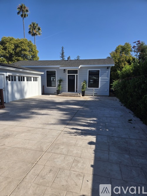 A house with a driveway and garage doors.