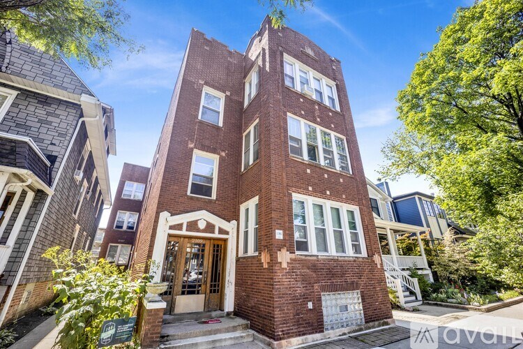A red brick building with a white door and windows.