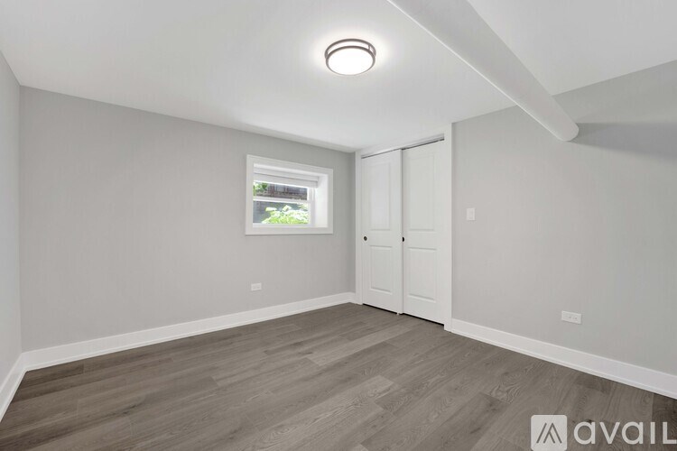 A room with a window and a door is available for rent.