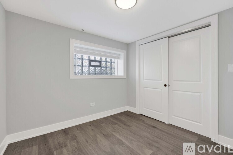 A room with a window and a door is available for rent.