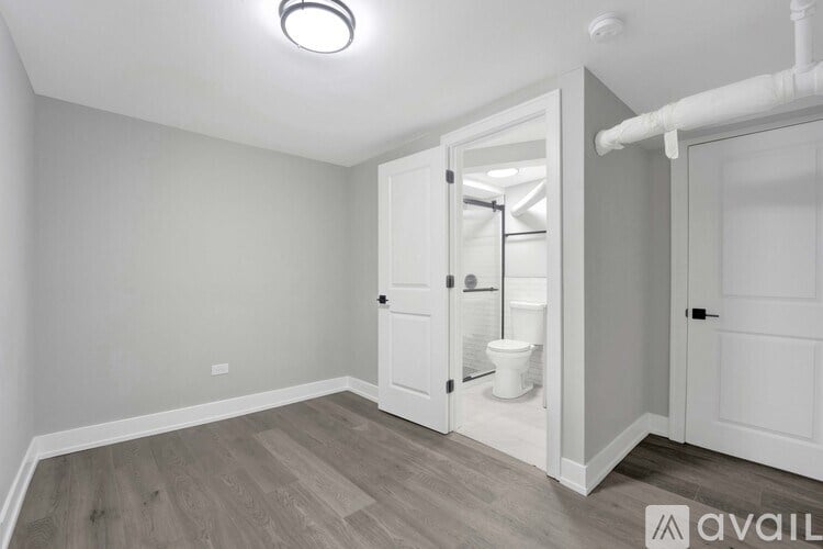 A bathroom with a toilet and sink visible through an open door.