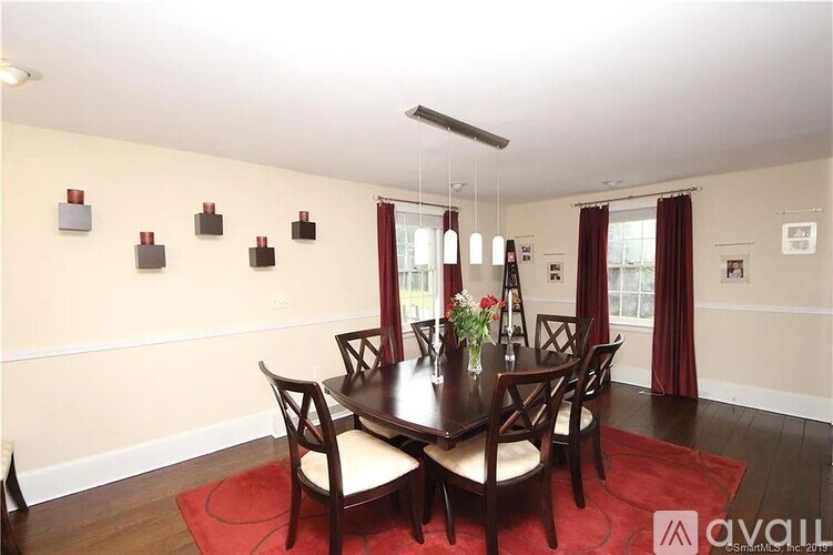 A dining room with a table set for four.