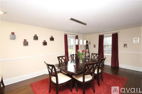 A dining room with a table set for four.
