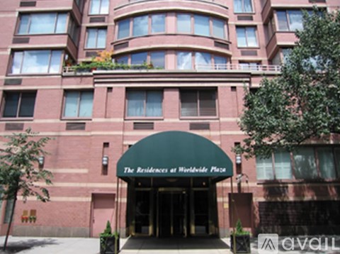 The Residences at Worldwide Place is a large red brick building with a green awning.