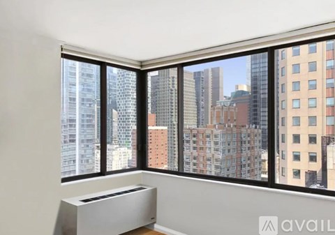 A large window with a view of a city skyline.