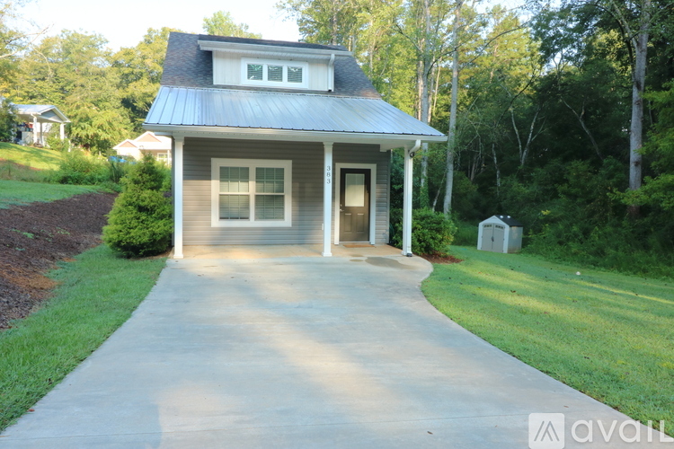 A house with a grey roof and a concrete driveway.