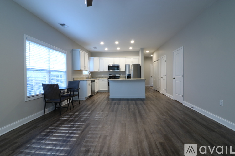 A kitchen with a dining table and chairs is available for rent.
