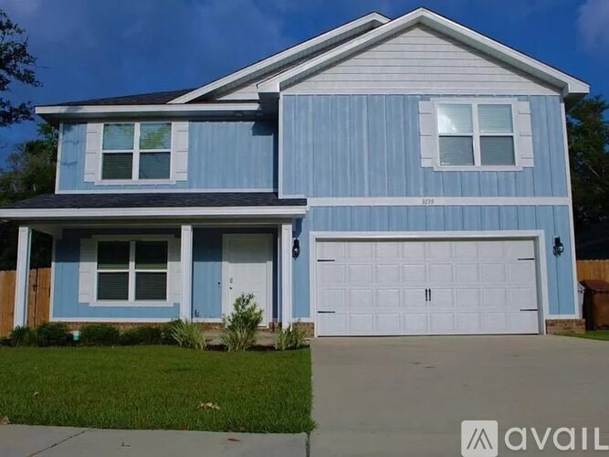 A blue house with a white garage door.