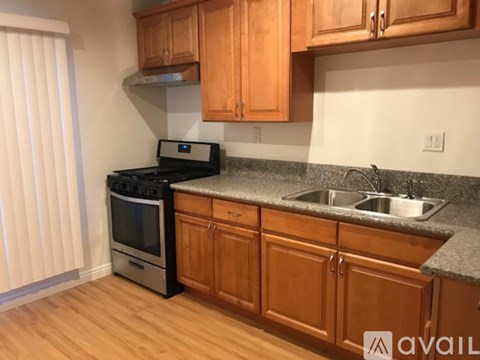 A kitchen with wooden cabinets and a granite countertop.