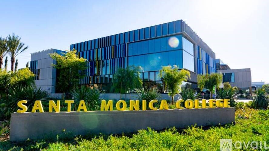 The image shows the front of Santa Monica College with a modern building and a sign in front.