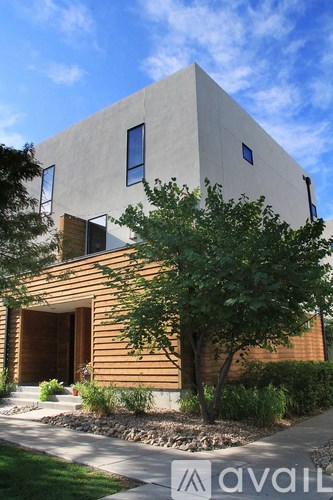A modern house with a flat roof and a wooden exterior.