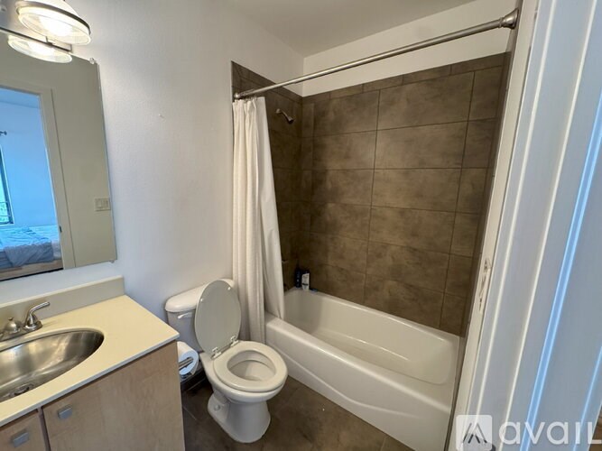 A bathroom with a toilet, sink, and bathtub.